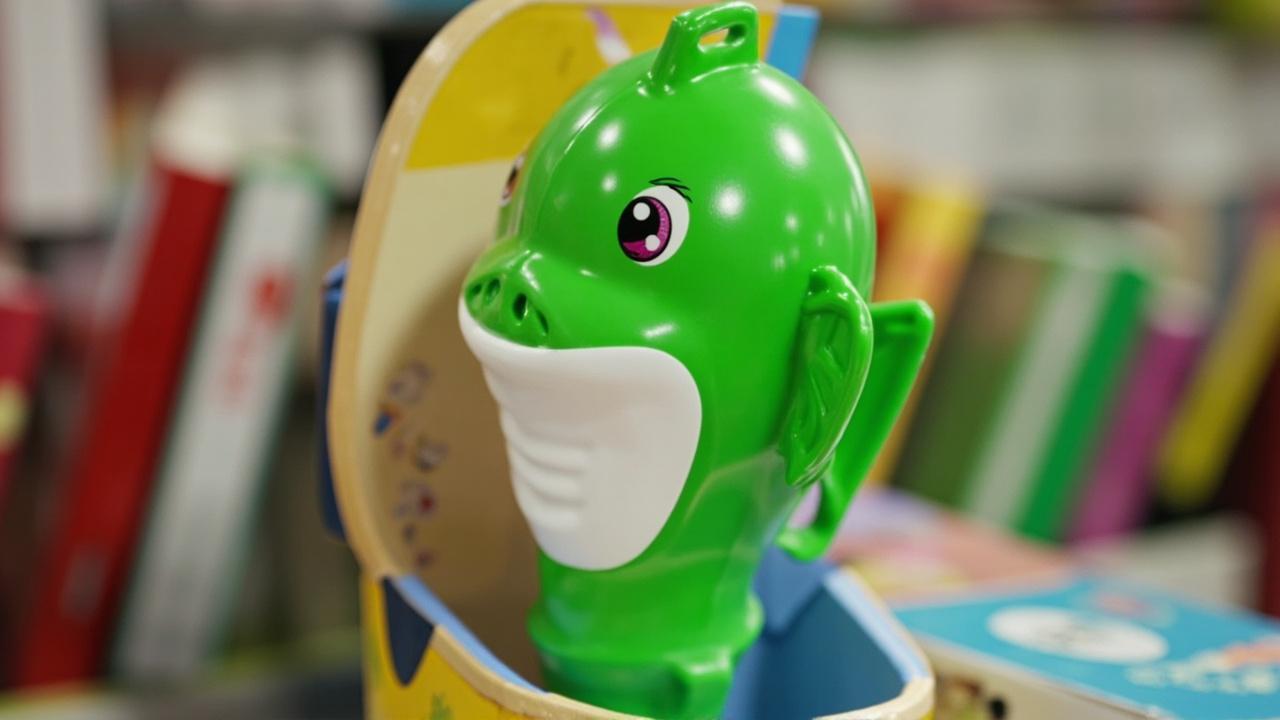 P2 fish reading pen in colorful gift packaging on a toy store shelf with board books